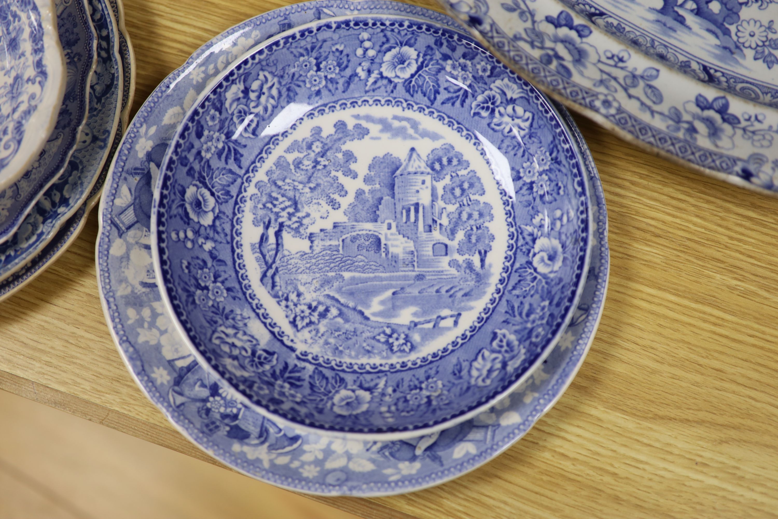 A collection of 19th and 20th century blue and white pottery plates and dishes